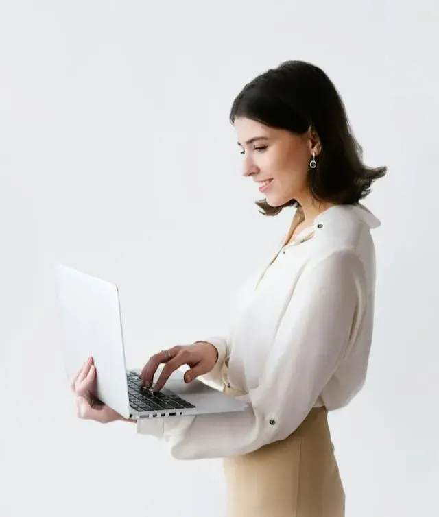 woman standing and holding laptop